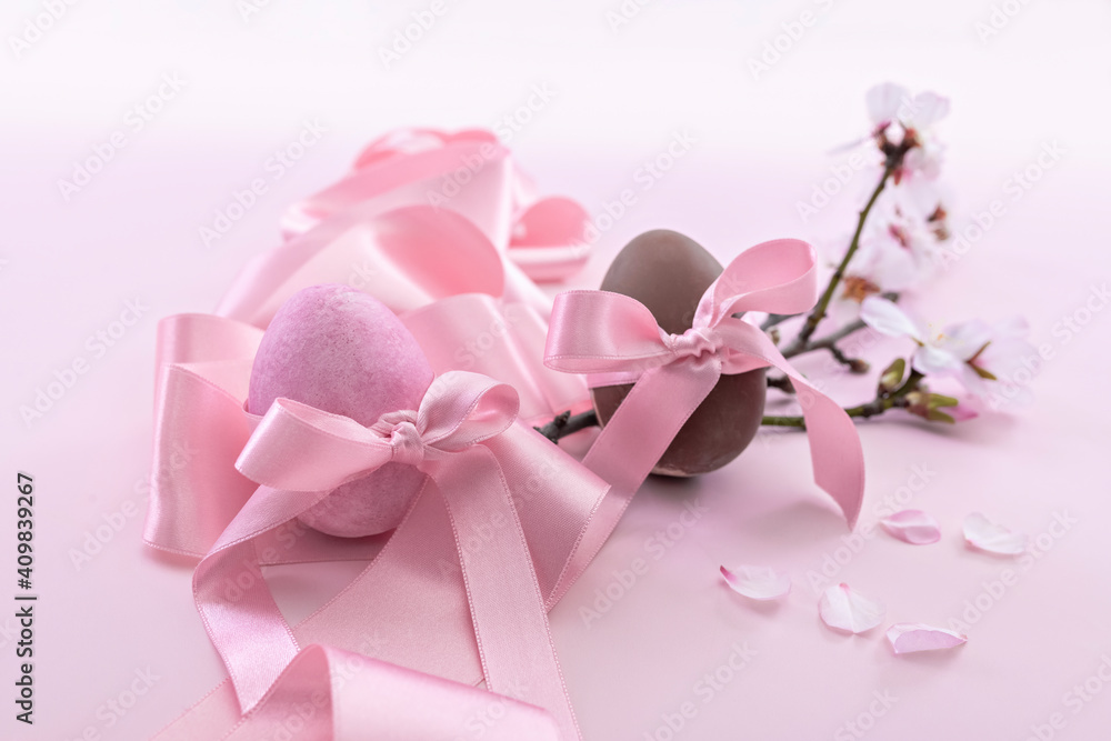 Easter eggs with pink ribbon and cherry blossoms