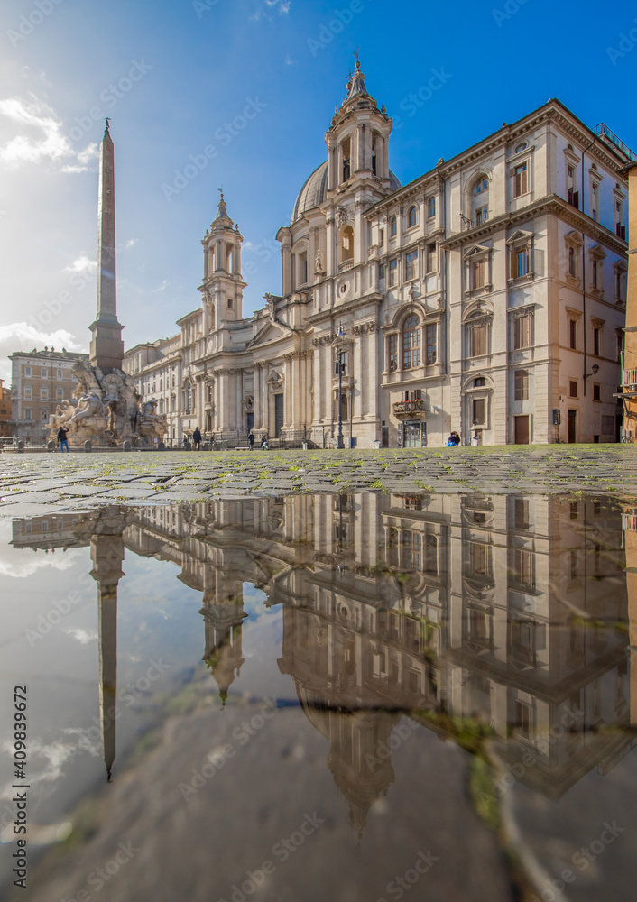 Obraz premium Rome, Italy - in Winter time, frequent rain showers create pools in which the wonderful Old Town of Rome reflect like in a mirror. Here in particular Piazza Navona
