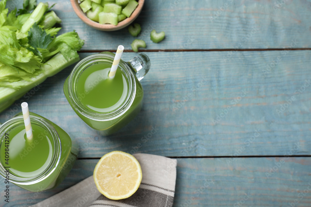 Celery juice and fresh ingredients on blue wooden table, flat lay. Space for text