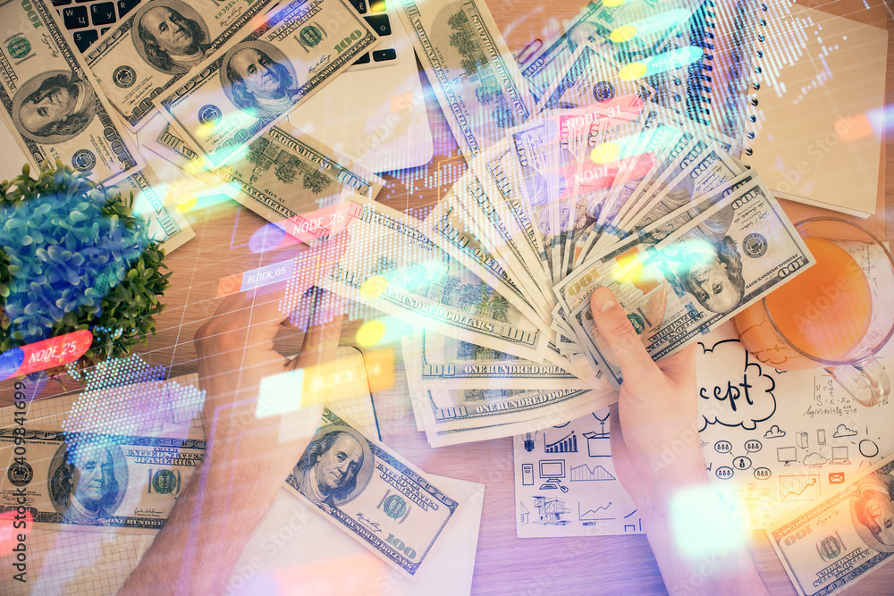 Multi exposure of technology drawing hologram and us dollars bills and man hands. Data concept Multi exposure of technology drawing hologram and us dollars bills and man hands. Data concept