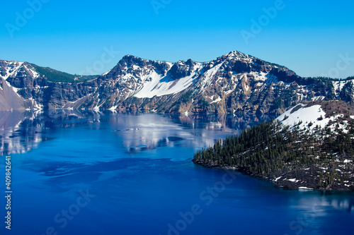 Beautiful Mountain range around blue water in the Crater Lake National Park, Oregon