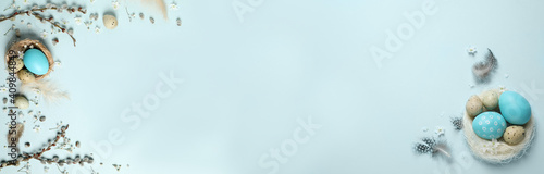 Photography Flat lay composition with colorful Easter eggs on light blue background, space for text