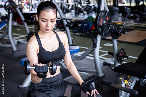 Woman holding dumbbell in the gym.