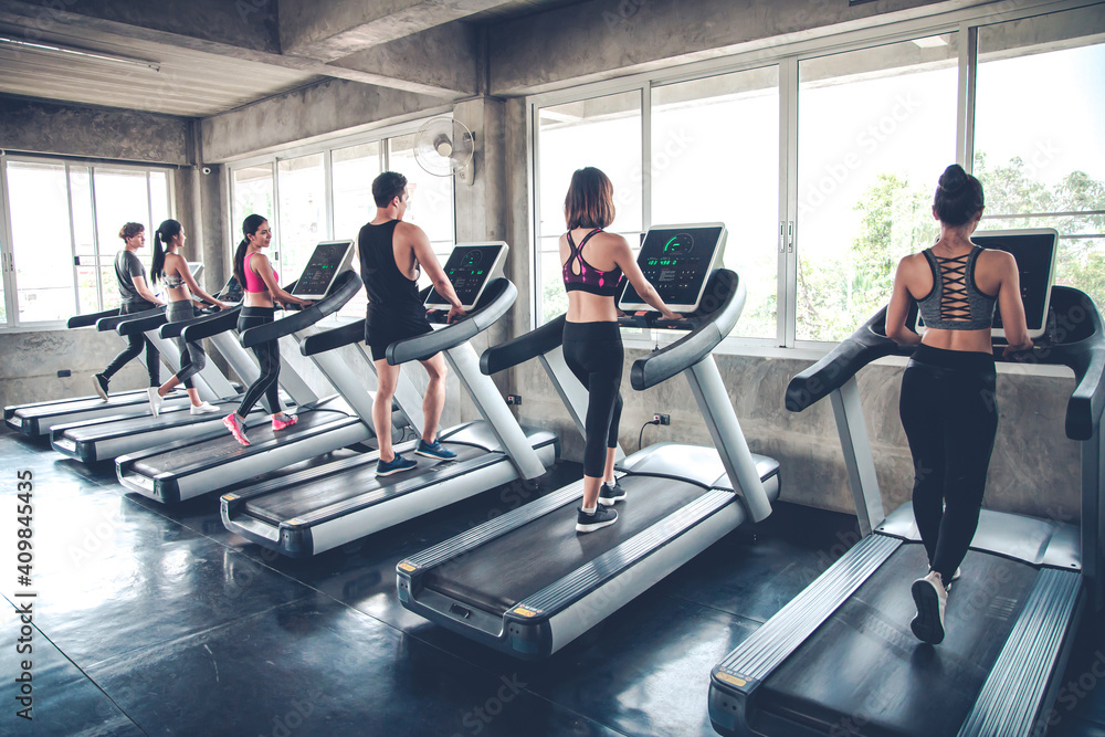 Fototapeta premium People jogging on treadmills.