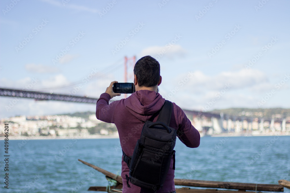 Young man taking photos with phone