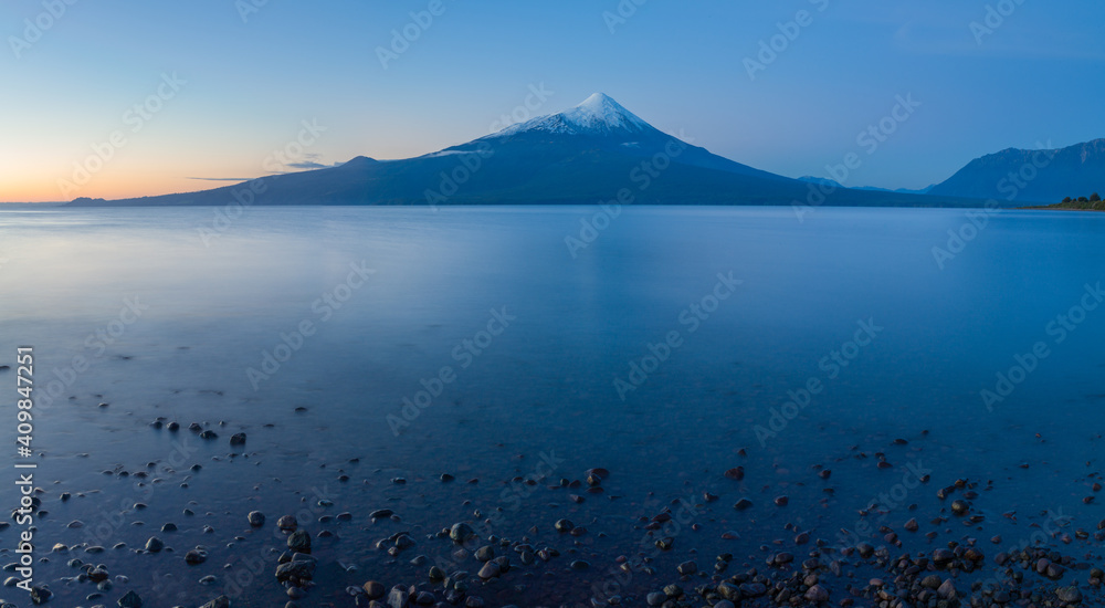 The lake Lago Llanquihue and the snow capped volcano Osorno in Chile in the blue hour after sunset The lake Lago Llanquihue and the snow capped volcano Osorno in Chile in the blue hour after sunset