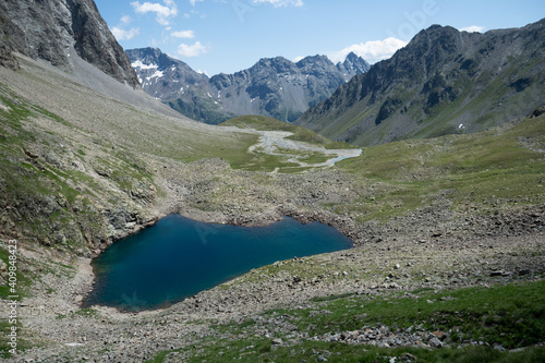 Fototapeta Naklejka Na Ścianę i Meble -  View to a deep blue lake in the mountains in Grisons, Switzerland