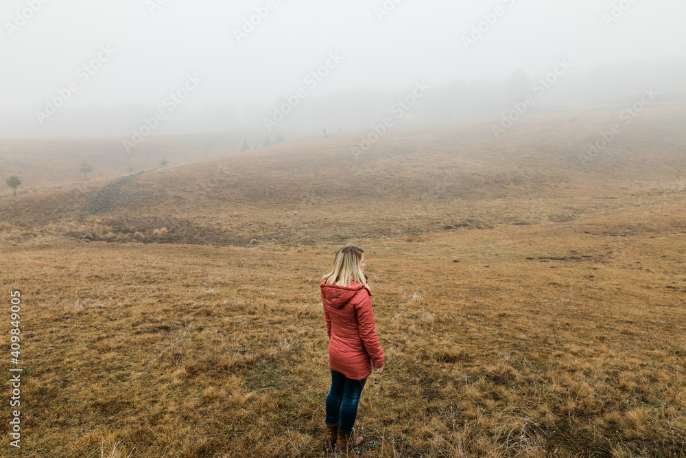 Young woman exploring nature in the foggy winter morning Young woman exploring nature in the foggy winter morning