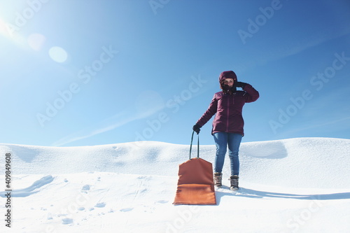 Young woman in the snow with slide