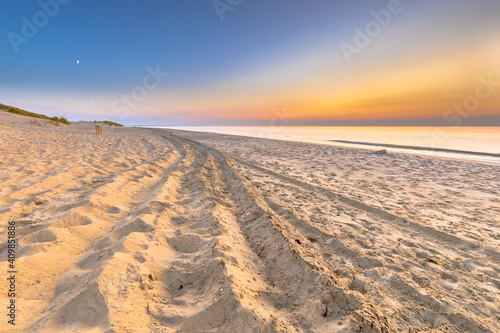 Car tracks Sunset View over ocean from dune in Zeeland