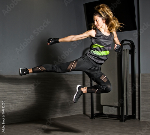 Young athlete woman practicing bodycombat photo