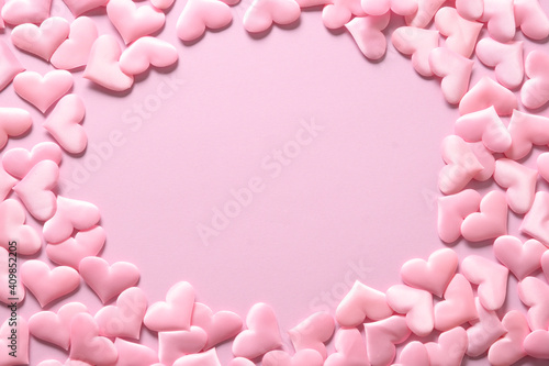 Pink romantic hearts as frame on pink background. Valentine's day greeting card with copy space.
