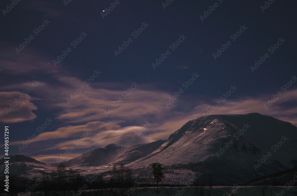 floating clouds over snowy mountain peak