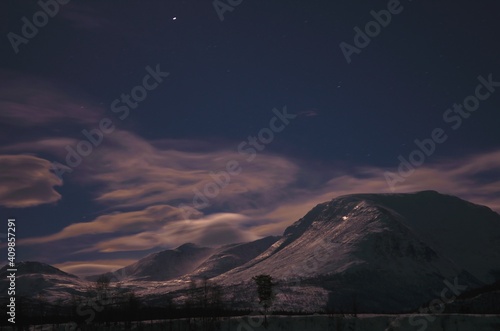 floating clouds over snowy mountain peak