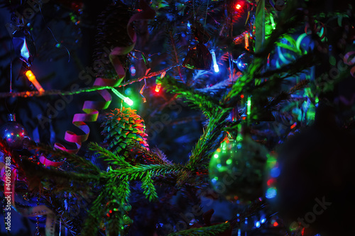 Decorated Christmas tree and glowing garland close-up.