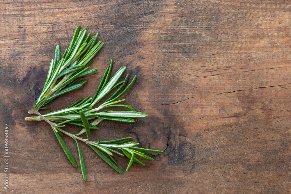 Fresh rosemary herb on wooden background. Top view rosemary with copy space.. Fresh rosemary herb on wooden background. Top view rosemary with copy space..