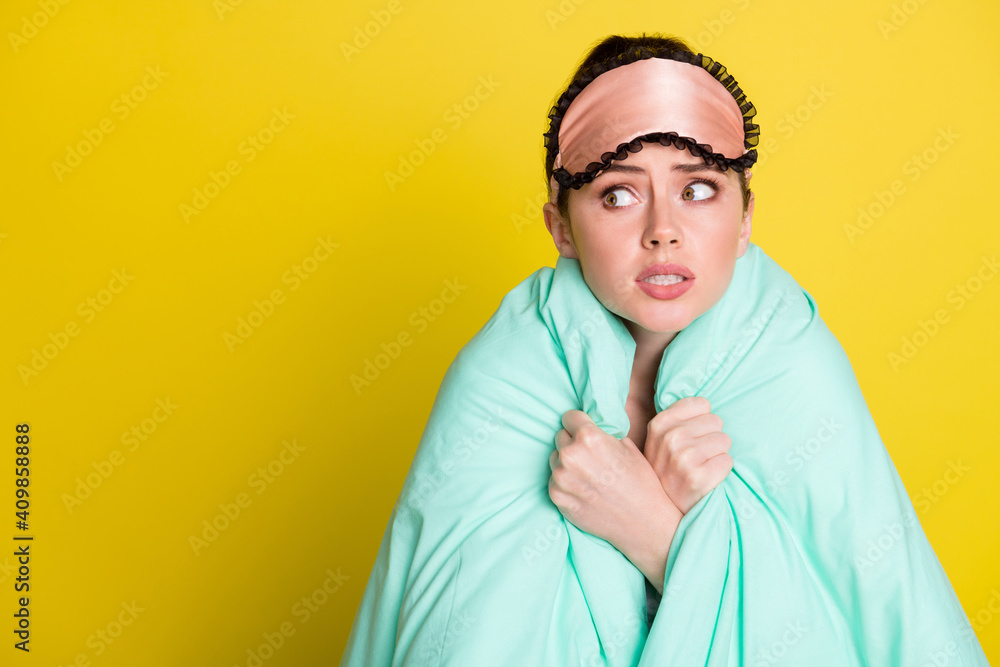 Photo of worried upset woman dressed nightwear mask covering blanket looking empty space isolated yellow color background Photo of worried upset woman dressed nightwear mask covering blanket looking empty space isolated yellow color background