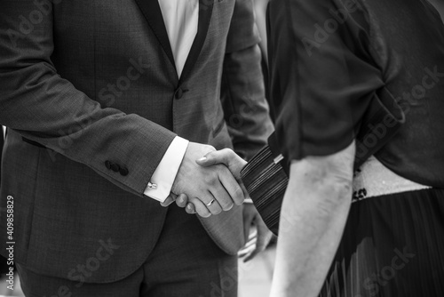 Business people shaking hands at meeting or negotiation, close-up. Friend welcome, introduction, greet or thanks gesture, product advertisement, partnership approval.