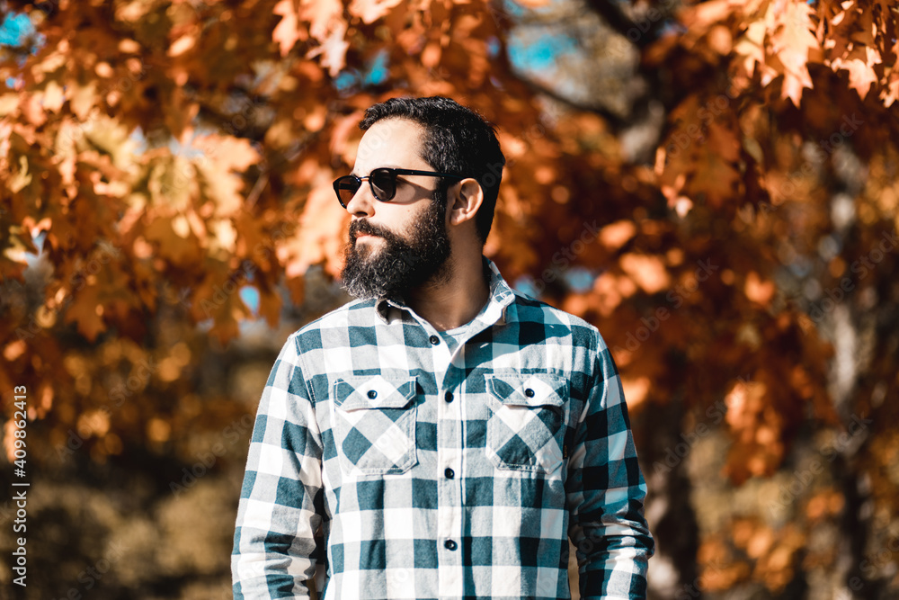 Single man outside in sunglasses plaid clothing autumn fall Single man outside in sunglasses plaid clothing autumn fall