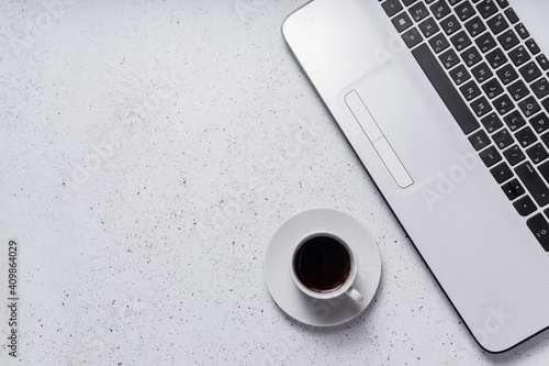 workplace. copyspace. top view. laptop keyboard next to a small cup of espresso coffee