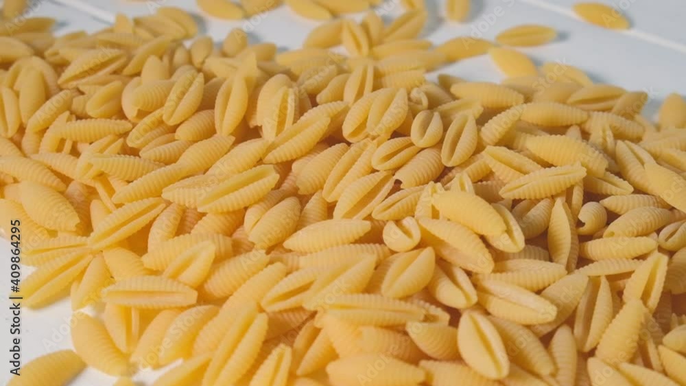 Italian pasta concept. Uncooked raw Italian gnocchetti sardi pasta background. Italian pasta concept. Uncooked raw Italian gnocchetti sardi pasta background.