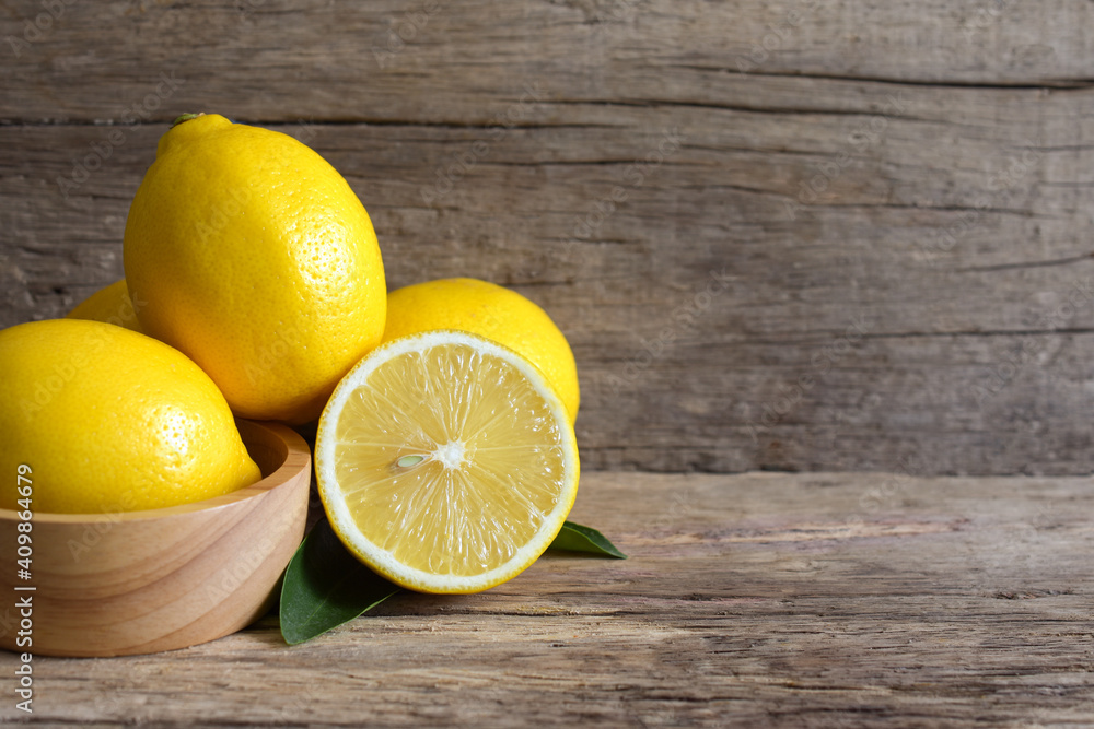 Fresh lemon and sliced on the wooden table,copy space. Fresh lemon and sliced on the wooden table,copy space.