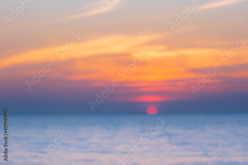 blurred of Tropical Colorful sunset over ocean on the beach. at Thailand Tourism background with sea beach. Holiday journey destination © Ingon