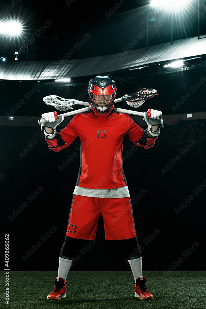 Lacrosse Player, athlete sportsman in red helmet on stadium background. Sport and motivation wallpaper.