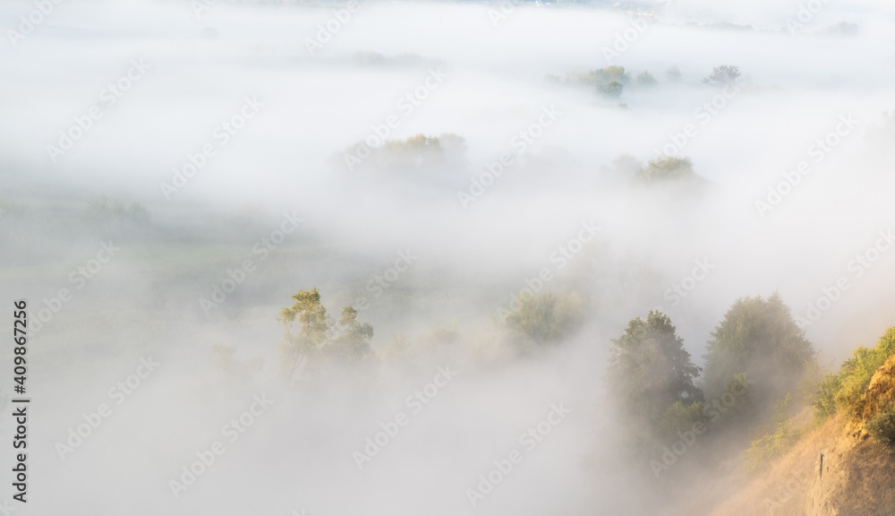 Thick morning fog lying in the valley Thick morning fog lying in the valley
