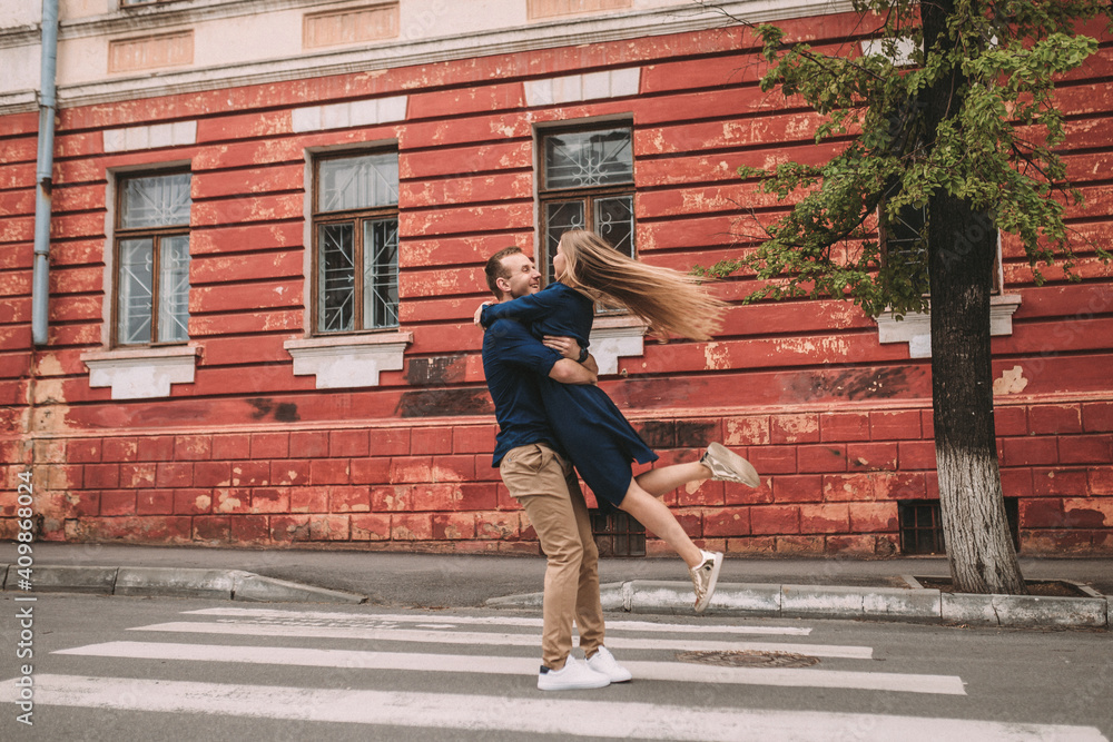Happy couple walking on the crosswalk in the city Happy couple walking on the crosswalk in the city