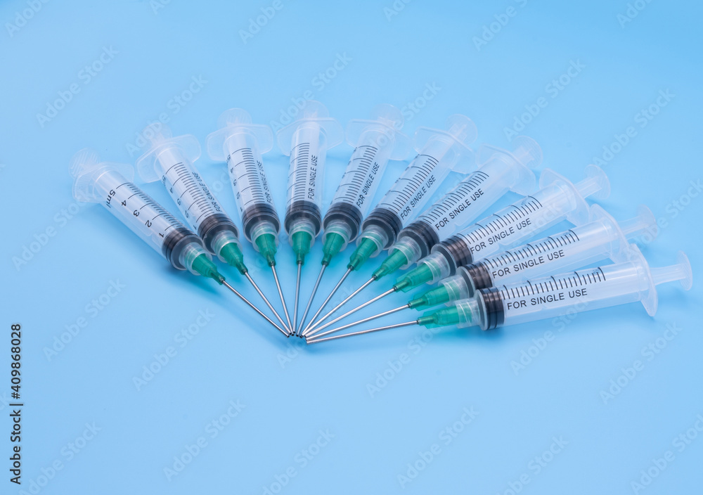 custom made wallpaper toronto digitalClear plastic syringes with needles isolated against a bue background