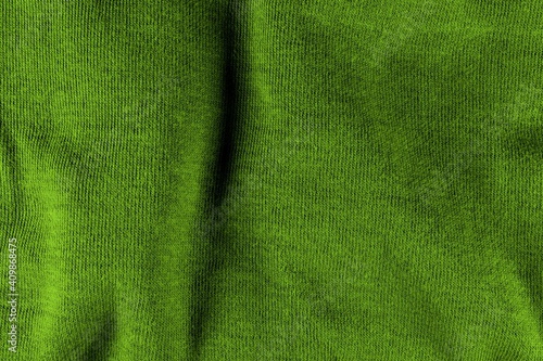 Green sweater texture with shadows. Green background