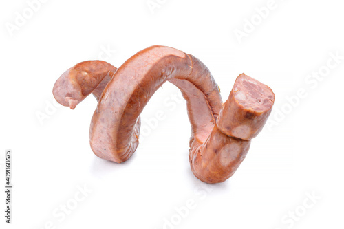 Smoked sausage twisted in a spiral and bound with a beechnut, isolated on a white background.