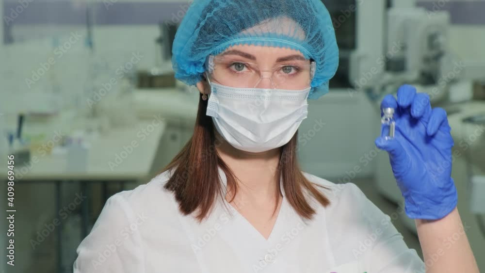 A nurse in a medical mask with a vaccine in hands in a laboratory. A nurse in a medical mask with a vaccine in hands in a laboratory.