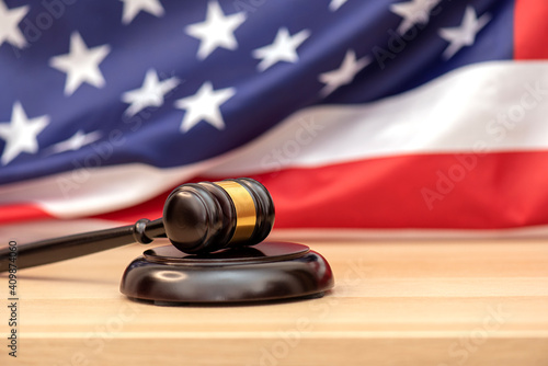 Wooden judge gavel USA flag as background, concept picture about justice in the USA