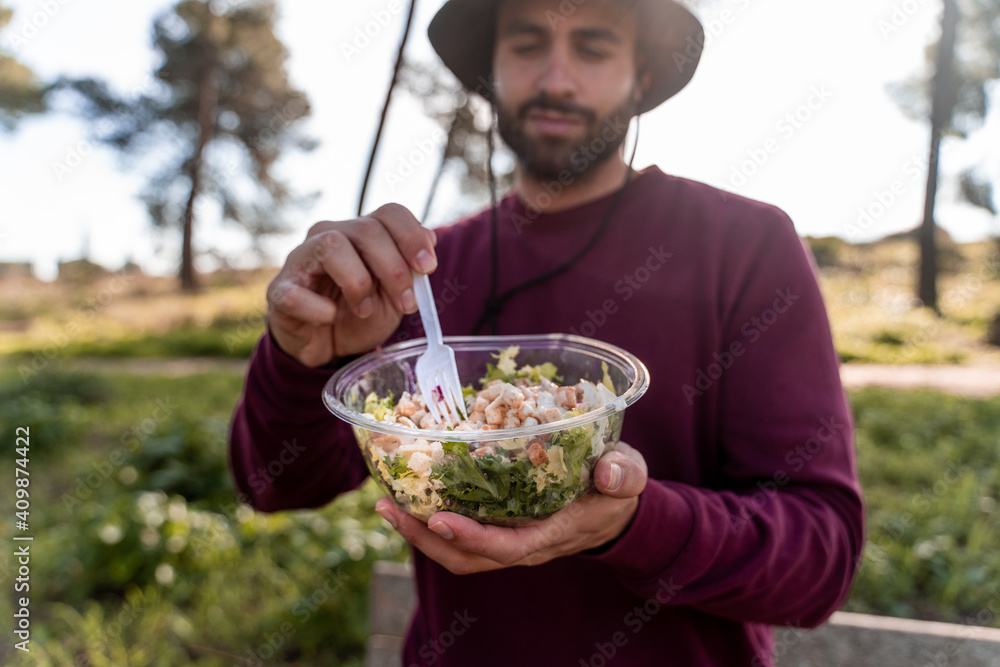 boy eating salad in nature