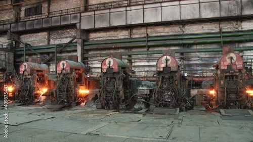 red hot metal bars in continuous casting machine at metallurgical plant