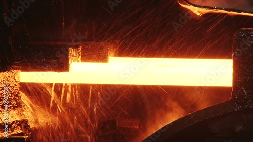 red hot metal bars in continuous casting machine at metallurgical plant