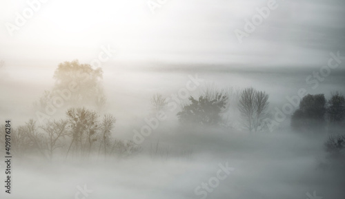 Atmospheric landscape covered with autumn mist