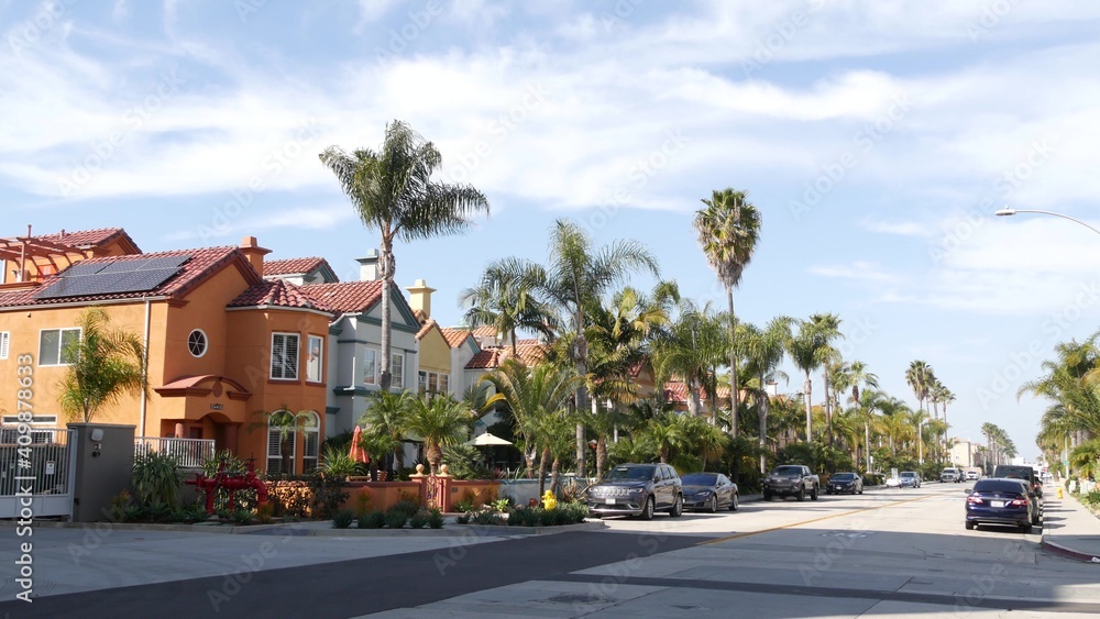 Obraz premium California typical suburban street, tropical Oceanside USA. Different colorful houses row. Generic american homes, buildings facade, townhouse exterior architecture. Residential district real estate.