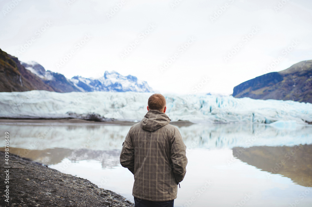 man enjoying view on ice and mountains man enjoying view on ice and mountains