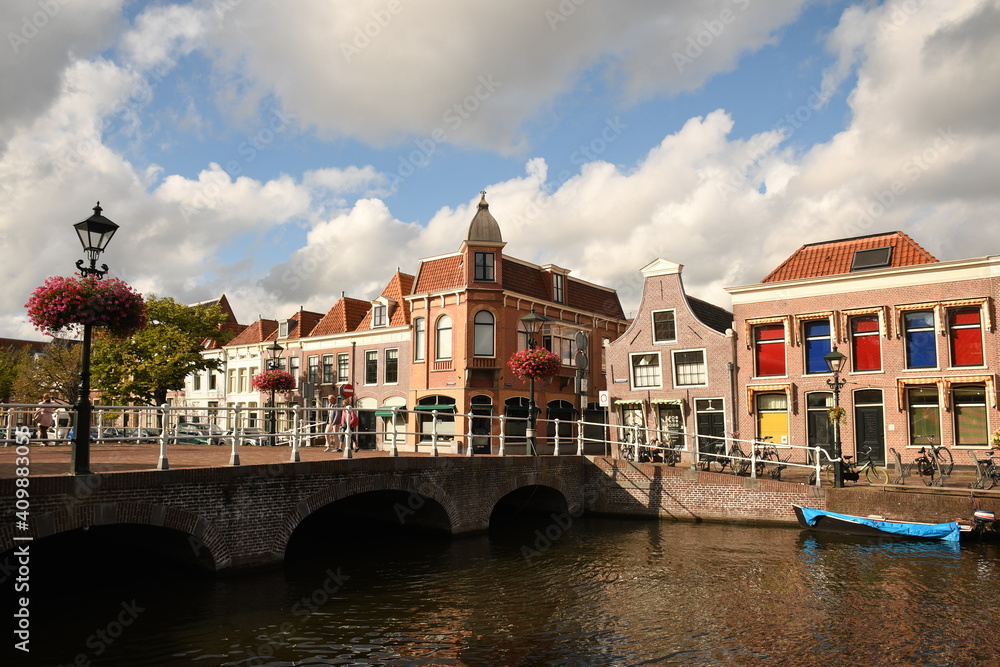 City view from the Oudegracht canal to the authentic buildings of Alkmaar in summer