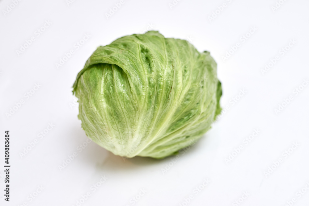 swing of fresh iceberg lettuce on white background