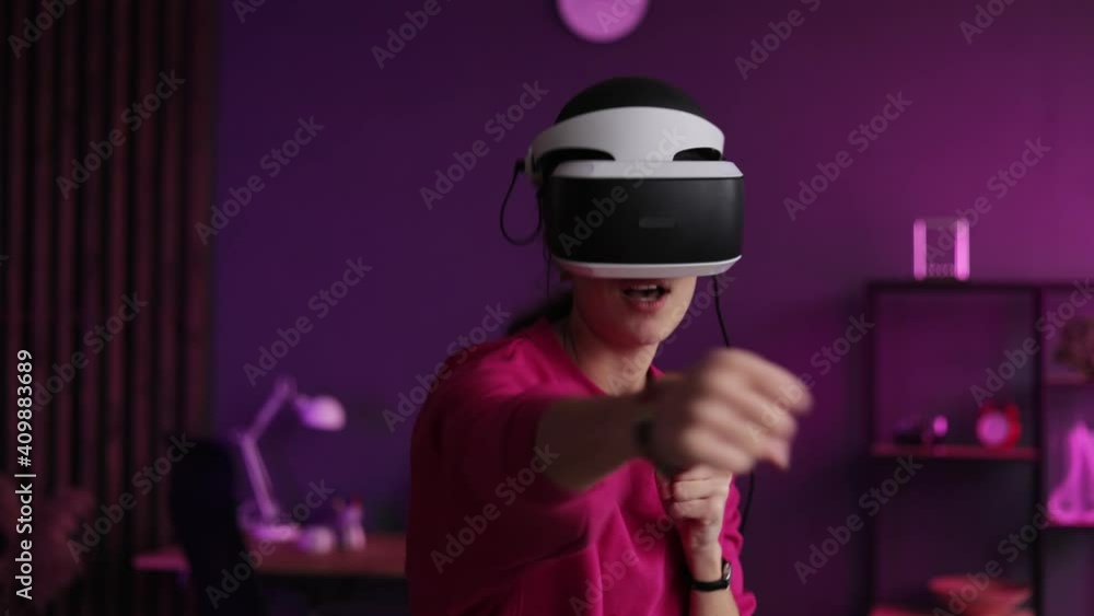 Gamer having fun with new technology console with virtual reality experience. Girl in vr glasses training in virtual reality. Woman boxing in VR 360 headset training for kicking in virtual reality. Gamer having fun with new technology console with virtual reality experience. Girl in vr glasses training in virtual reality. Woman boxing in VR 360 headset training for kicking in virtual reality.