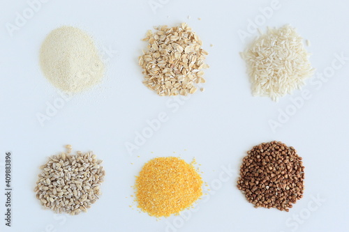 different cereals are poured on a white surface
