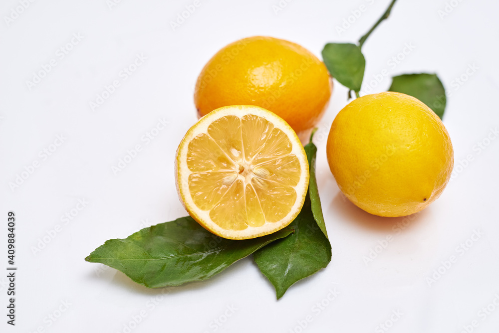 fresh lemon with branch on white background