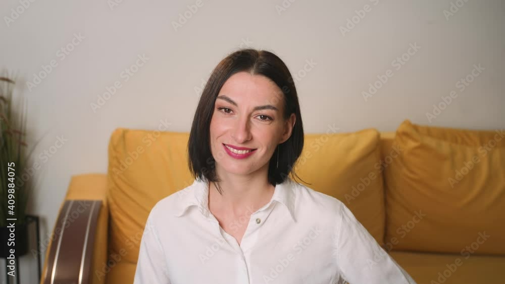 Portrait of confident smiling young attractive businesswoman looking at camera, successful beautiful happy woman at home office close up slow motion Portrait of confident smiling young attractive businesswoman looking at camera, successful beautiful happy woman at home office close up slow motion