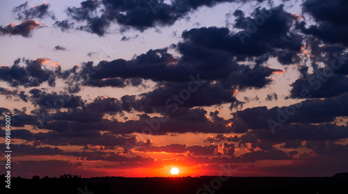 beautiful sunset sun and clouds over the trees