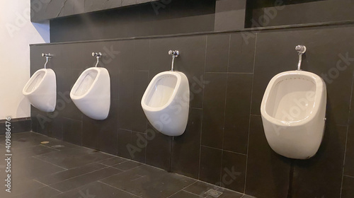 Men's white urinals design, Close up row of outdoor urinals men public toilet, Expulsion from the body, Urinals for men, Urinal concept.