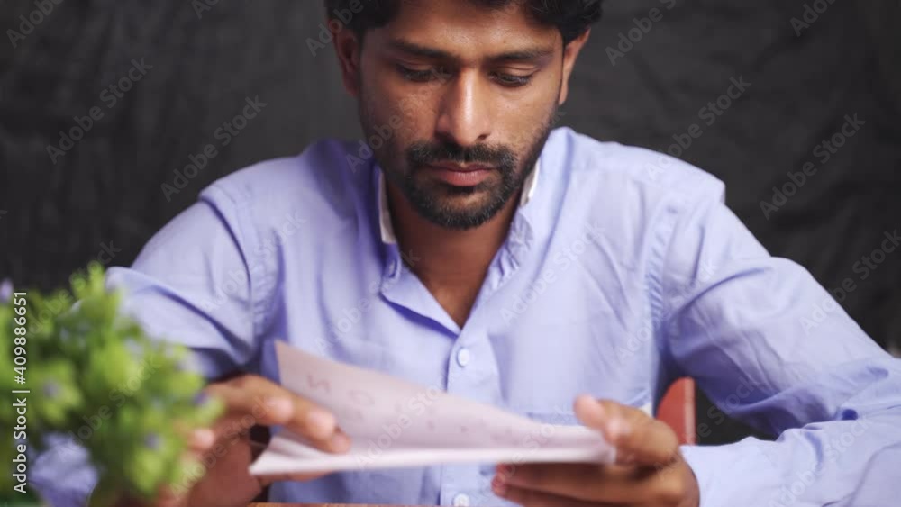 Close up of Young man got disappointed after reading mail paper letter - Concept of bad news, job termination, business deadline or eviction notice